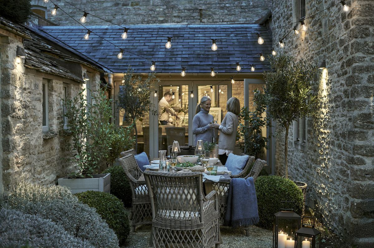 Neptune throws and cushions in outdoor dining area